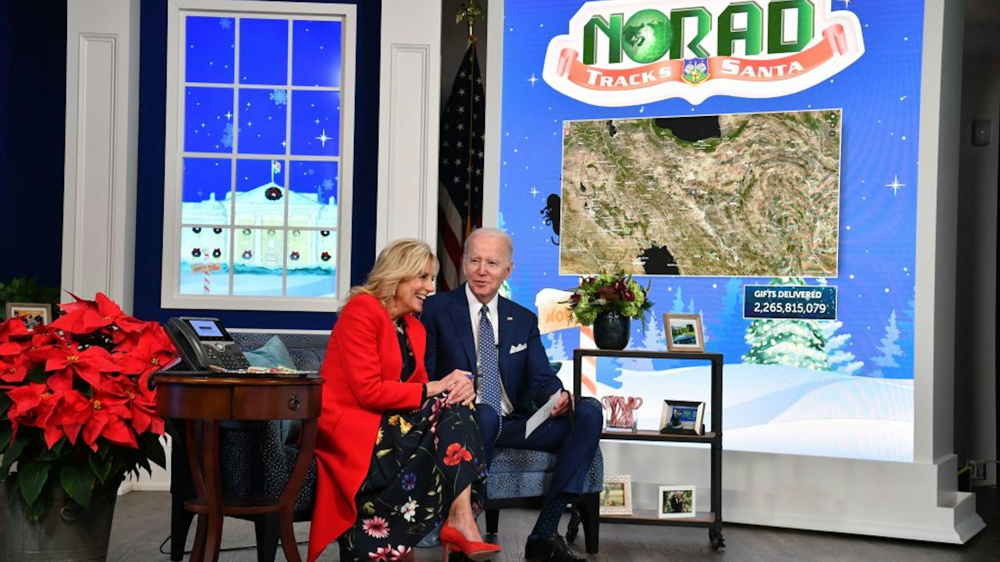 US President Joe Biden and First Lady Jill Biden speak with NORAD (North American Aerospace Defense Command) from the South Auditorium of the White House in Washington, DC, as NORAD tracks Santa Claus' travel over the globe delivering gifts on December 24, 2021. (Photo by Nicholas Kamm / AFP) (Photo by NICHOLAS KAMM/AFP via Getty Images)