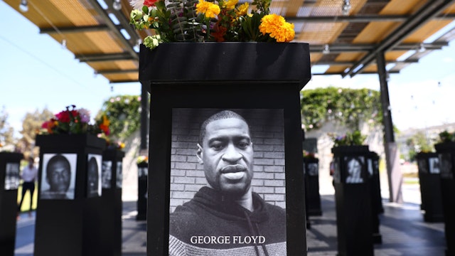 SAN DIEGO, CALIFORNIA - JULY 20: A photograph of George Floyd (C) is displayed along with other photographs at the Say Their Names memorial exhibit at Martin Luther King Jr. Promenade on July 20, 2021 in San Diego, California. The traveling memorial features photographs of 200 Black Americans who lost their lives due to systemic racism and racial injustice and is sponsored by the San Diego African American Museum of Fine Art (SDAAMFA). Former Minneapolis police officer Derek Chauvin was sentenced to 22 years and six months in prison after being convicted of murder in the death of George Floyd. (Photo by Mario Tama/Getty Images)