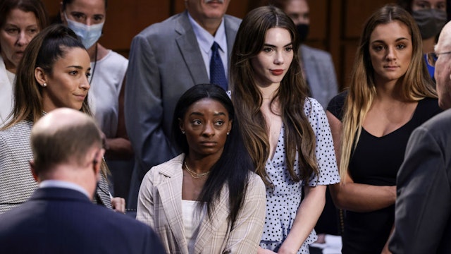 WASHINGTON, DC - SEPTEMBER 15: (L-R) U.S. Olympic Gymnasts Aly Raisman, Simone Biles, McKayla Maroney and NCAA and world champion gymnast Maggie Nichols are approached by Sen. Pat Leahy (D-VT) after their testimony during a Senate Judiciary hearing about the Inspector General's report on the FBI handling of the Larry Nassar investigation of sexual abuse of Olympic gymnasts, on Capitol Hill on September 15, 2021 in Washington, DC. Biles and other fellow U.S. Gymnasts gave testimony on the abuse they experienced at the hand of Larry Nassar, the former US women's national gymnastics team doctor, and the FBI’s lack of urgency when handling their cases. (Photo by Anna Moneymaker/Getty Images)