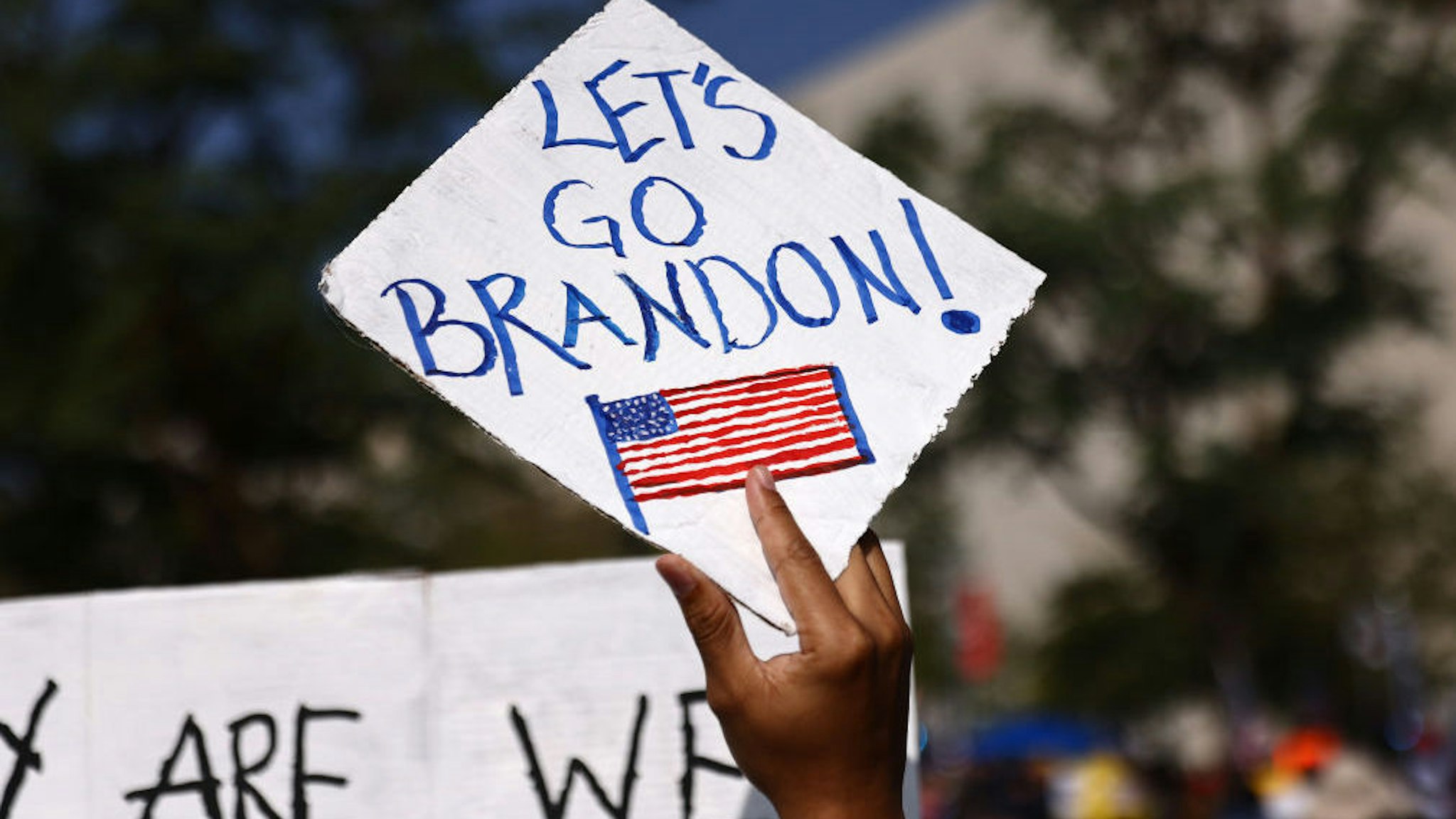 A protestor holds a 'Let's Go Brandon!' sign in Grand Park at a ‘March for Freedom’ rally demonstrating against the L.A. City Council’s COVID-19 vaccine mandate for city employees and contractors on November 8, 2021 in Los Angeles, California.