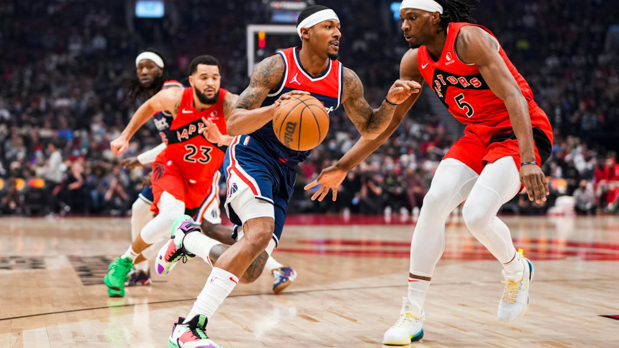 TORONTO, ON - DECEMBER 5: Bradley Beal #3 of the Washington Wizards drives against Precious Achiuwa #5 of the Toronto Raptors during the first half of their basketball game at the Scotiabank Arena on December 5, 2021 in Toronto, Ontario, Canada. NOTE TO USER: User expressly acknowledges and agrees that, by downloading and/or using this Photograph, user is consenting to the terms and conditions of the Getty Images License Agreement. (Photo by Mark Blinch/Getty Images)