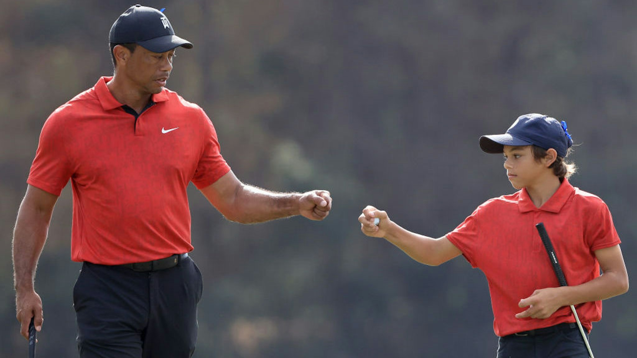 ORLANDO, FLORIDA - DECEMBER 19: Tiger Woods and Charlie Woods celebrate a birdie on the 13th hole during the final round of the PNC Championship at the Ritz Carlton Golf Club Grande Lakes on December 19, 2021 in Orlando, Florida. (Photo by Sam Greenwood/Getty Images)