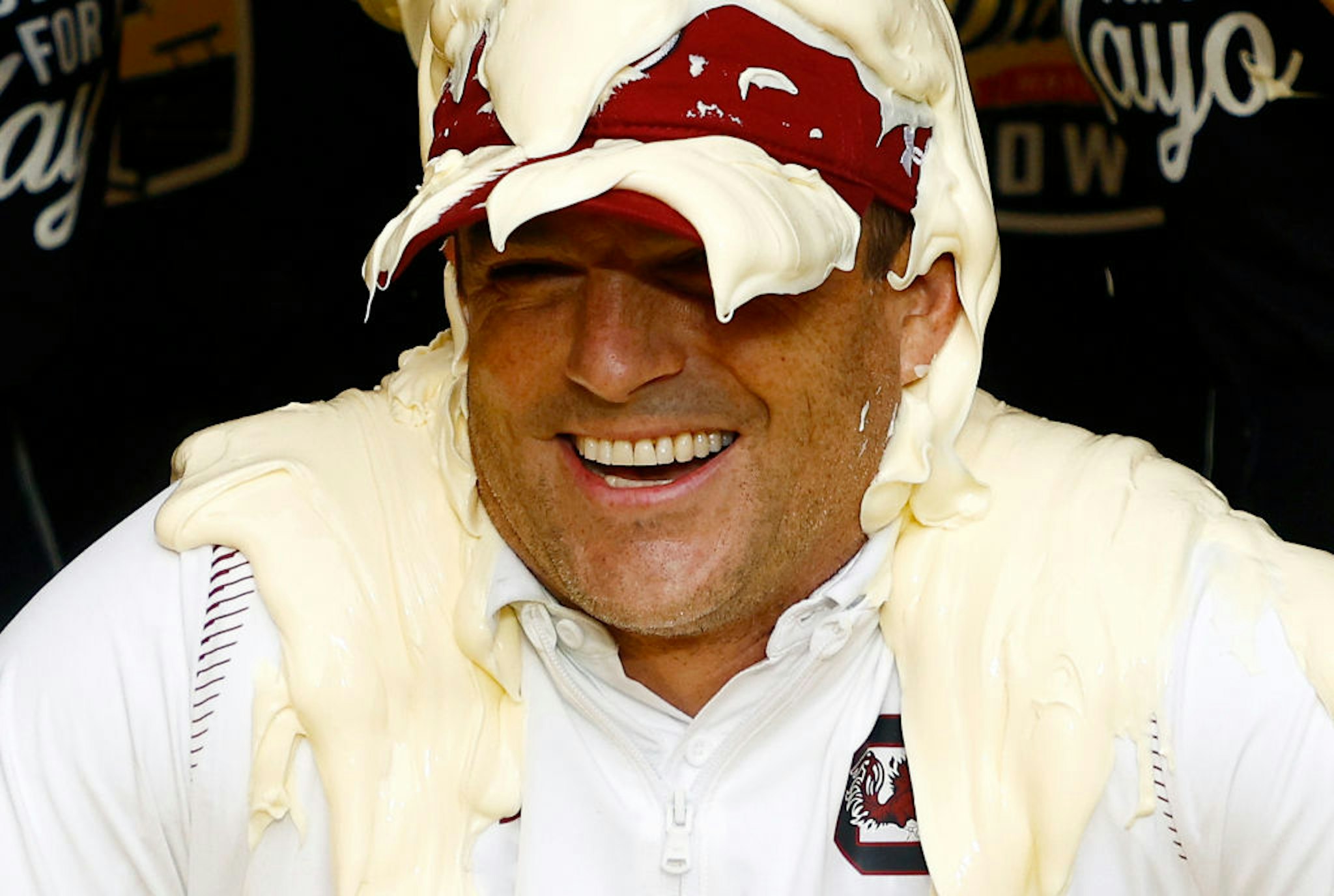 Head coach Shane Beamer of the South Carolina Gamecocks is covered in Duke's Mayonnaise following their 38-21 victory over the North Carolina Tar Heels in the Duke's Mayo Bowl at Bank of America Stadium on December 30, 2021 in Charlotte, North Carolina