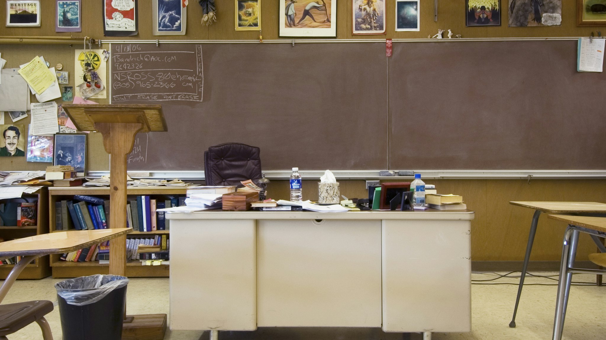 Classroom with teacher's desk in middle of room - stock photo