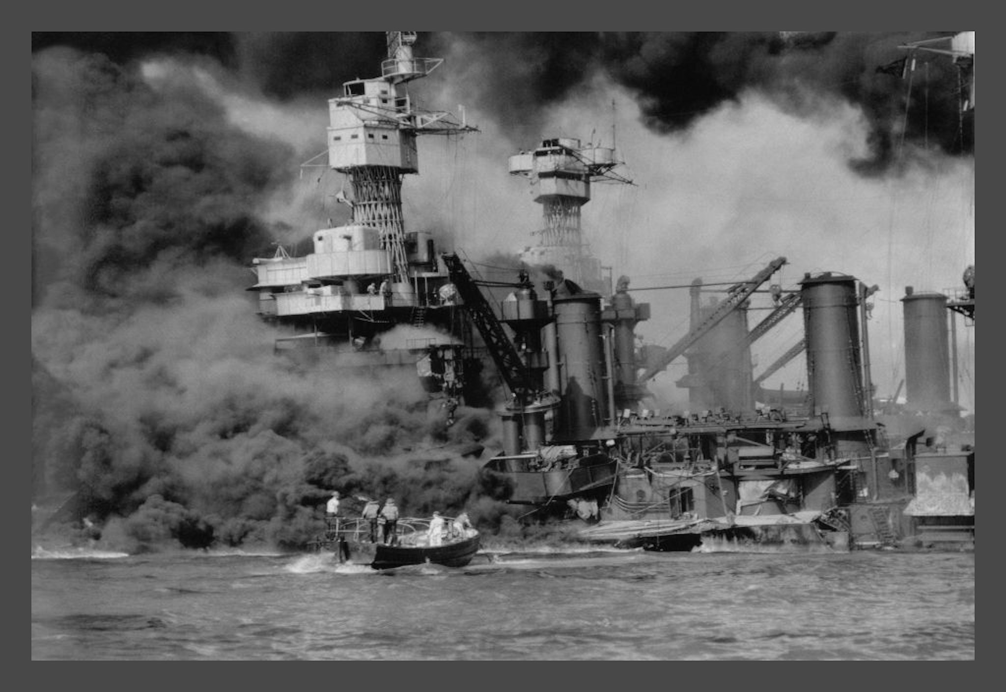 UNITED STATES - CIRCA 1941: On December 7, 1941 the Japanese attacked Pearl Habor in Hawaii. In one attack they sunk almost the entire Pacific Fleet. This photograph shows the USS West Virginia on fire and the upper part of the USS Tenessee, already under the water. (Photo by Buyenlarge/Getty Images)