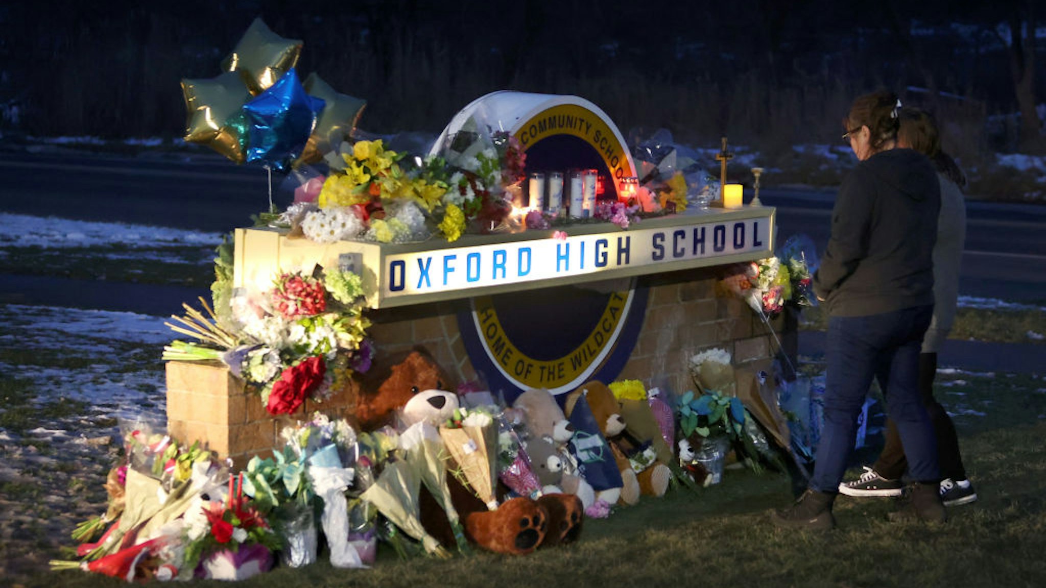 OXFORD, MICHIGAN - DECEMBER 01: People visit a makeshift memorial outside of Oxford High School on December 01, 2021 in Oxford, Michigan. Yesterday, four students were killed and seven injured when student Ethan Crumbley allegedly opened fire on fellow students at the school.