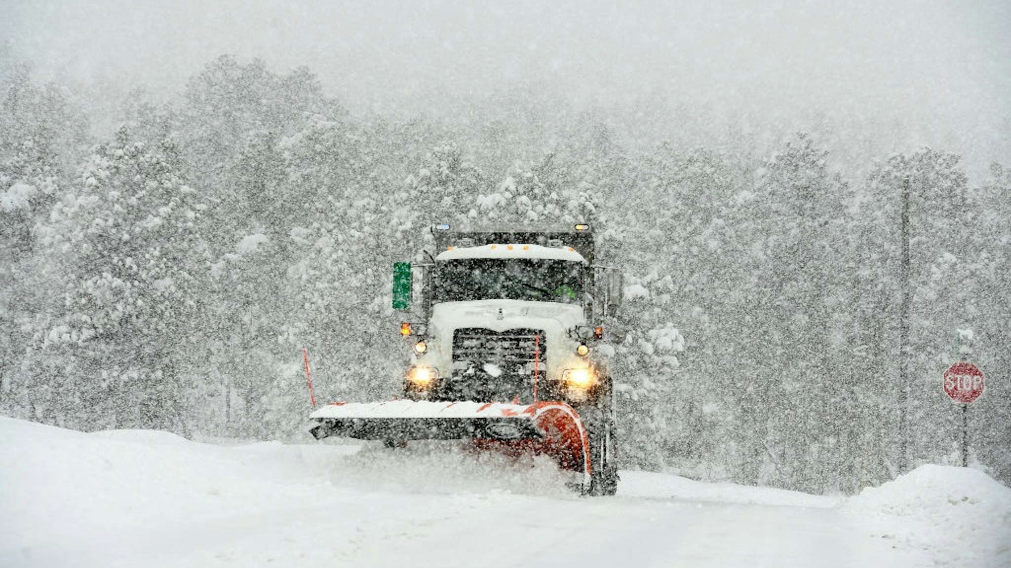 NEDERLAND, COLORADO - MARCH 14: A snowplow comes off of Highway 119 to plow Ridge Road on March 14, 2021 in Nederland, Colorado.