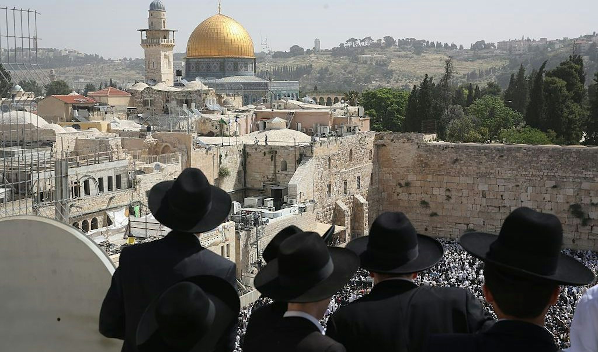 Jewish men take part in the Cohanim prayer (priest's blessing) during the Pesach (Passover) holiday at the Western Wall in the Old City of Jerusalem on April 25, 2016. (MENAHEM KAHANA/AFP via Getty Images)