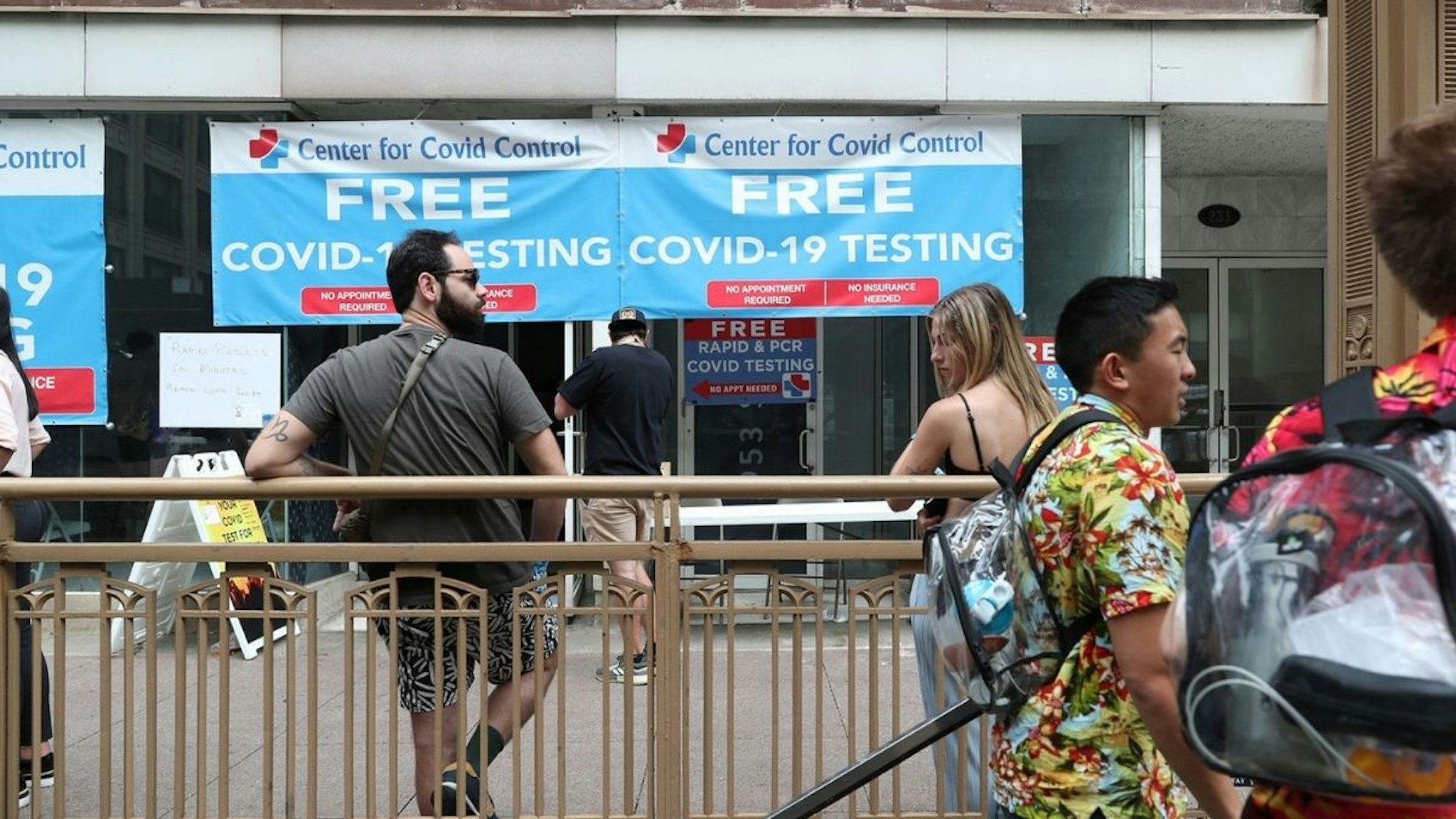 People wait for COVID-19 rapid test results before heading to Lollapalooza at a temporary testing site in the 200 block of South State Street on July 30, 2021, in Chicago.