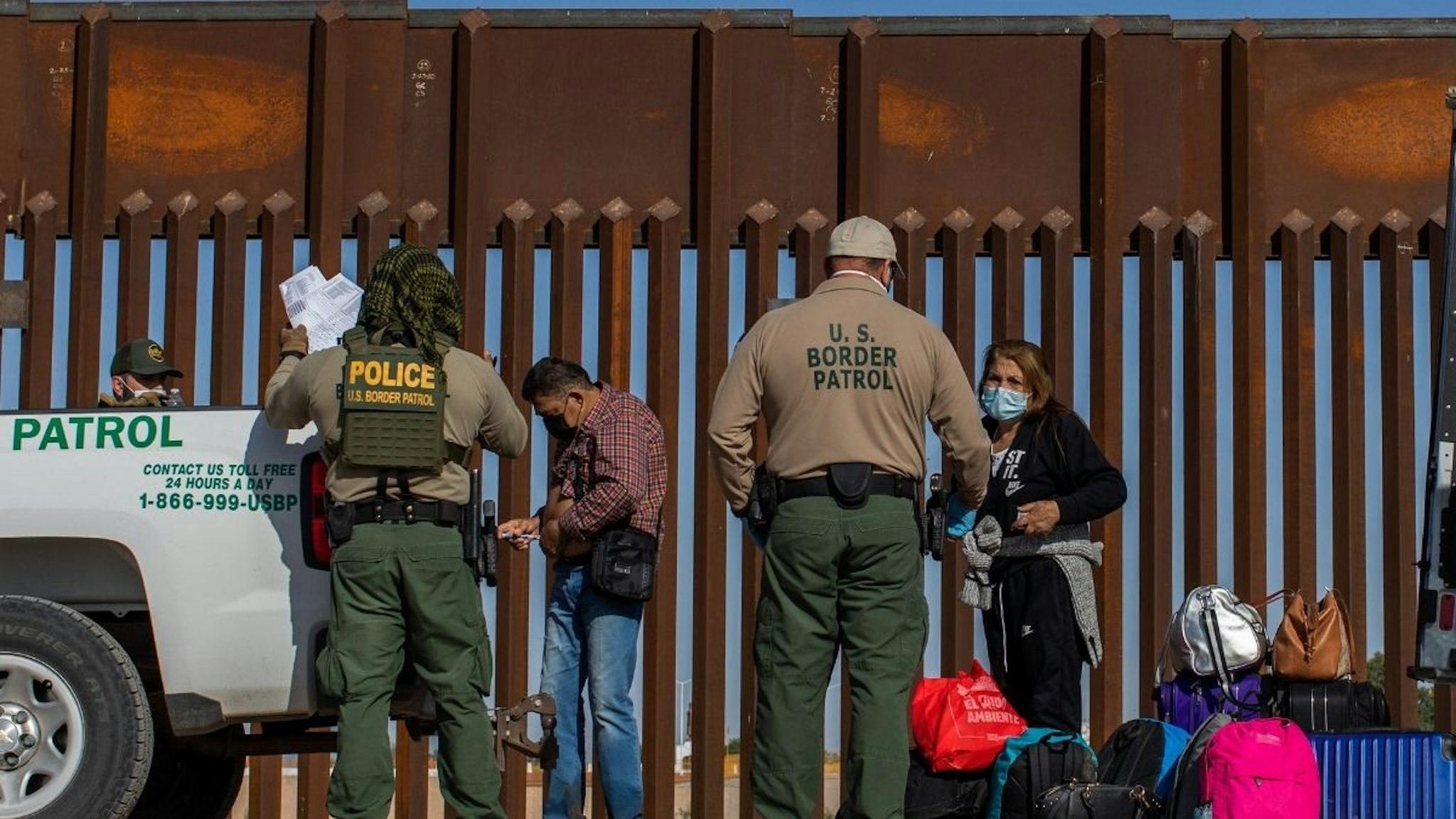 An asylum seeker from Colombia injects insulin after he turned himself in to US Border Patrol agents on May 13, 2021 in Yuma, Arizona.