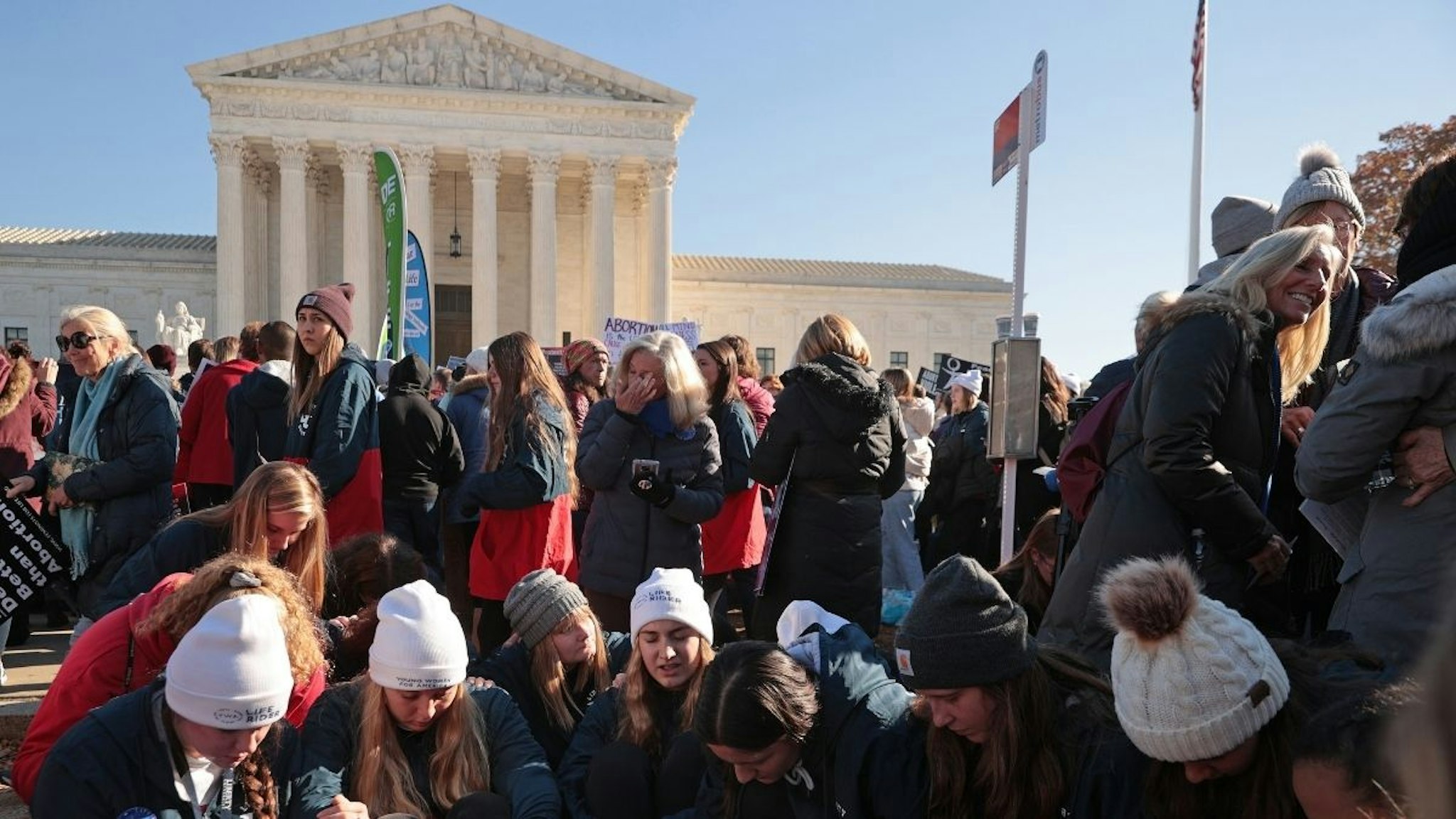 Students from Liberty University sit and pray in front of the U.S. Supreme Court as the justices hear hear arguments in Dobbs v. Jackson Women's Health, a case about a Mississippi law that bans most abortions after 15 weeks, on December 01, 2021 in Washington, DC.