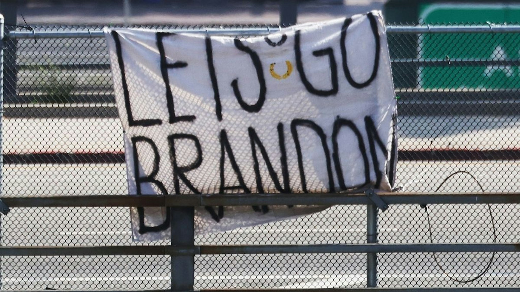 A 'Let's Go Brandon' sign hangs on an overpass near a ‘March for Freedom’ rally where people were demonstrating against the L.A. City Council’s COVID-19 vaccine mandate for city employees and contractors on November 8, 2021 in Los Angeles, California.