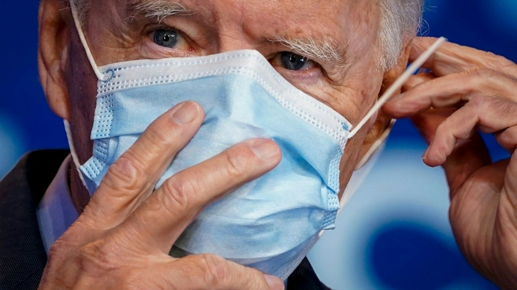 Democratic presidential nominee Joe Biden puts on his face mask after making remarks about the Affordable Care Act and COVID-19 after attending a virtual coronavirus briefing with medical experts at The Queen theater on October 28, 2020 in Wilmington, Delaware.