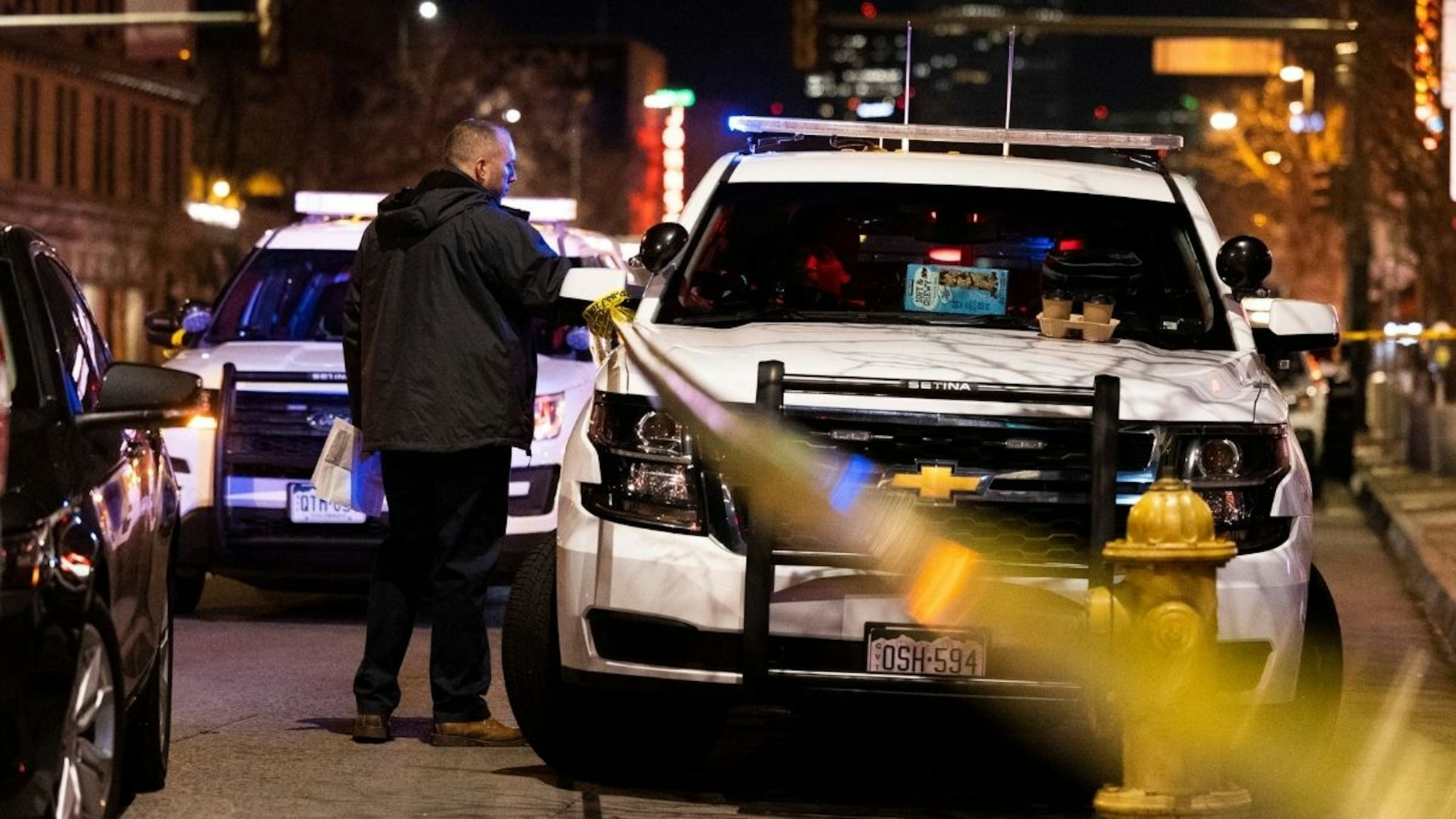 Police work the scene outside the Sol Tribe tattoo shop on Broadway where two women were shot and killed and a man injured on December 27, 2021 in Denver, Colorado.
