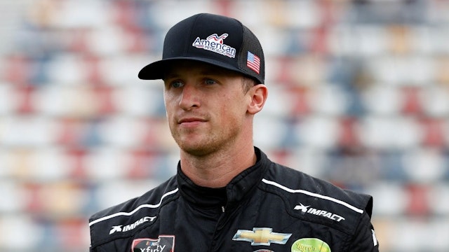 Brandon Brown, driver of the #68 American PetroLog Chevrolet, walks the grid prior to the NASCAR Xfinity Series Drive for the Cure 250 presented by Blue Cross Blue Shield of North Carolina at Charlotte Motor Speedway on October 09, 2021 in Concord, North Carolina.