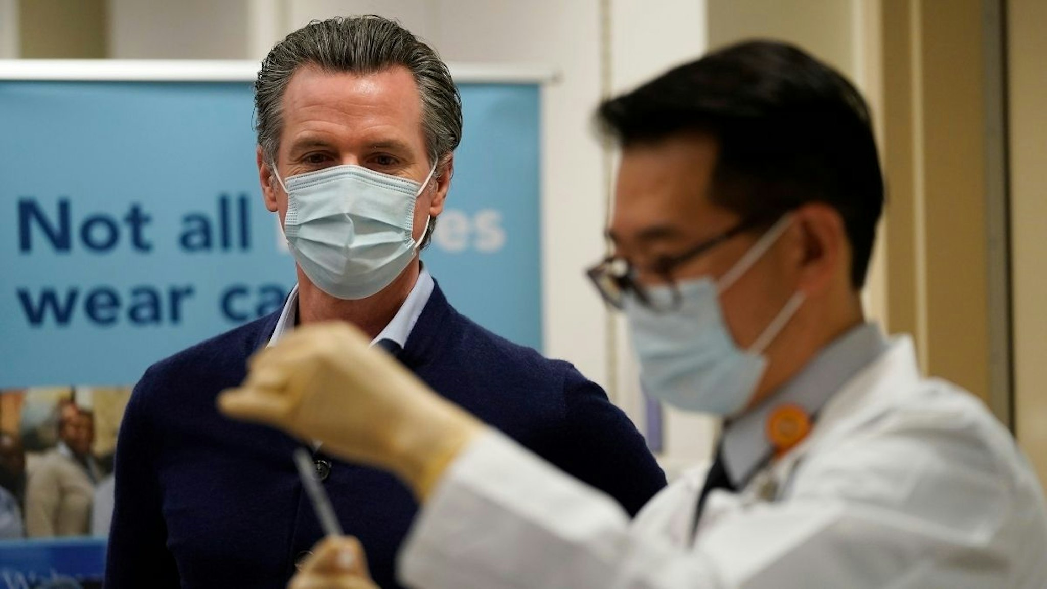 Gov. Gavin Newsom watches as the Pfizer-BioNTech COVID-19 vaccine is prepared by Director of Inpatient Pharmacy David Cheng at Kaiser Permanente Los Angeles Medical Center on December 14, 2020 in Los Angeles, California.