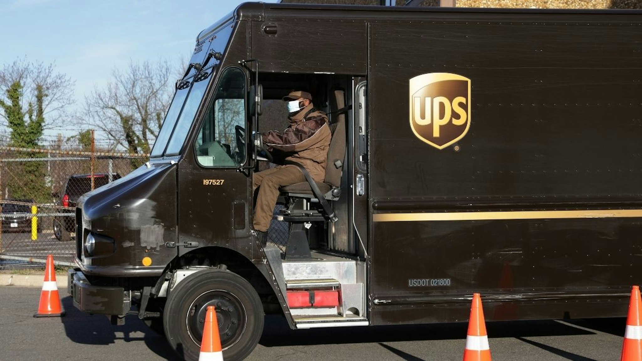 A United Parcel Service (UPS) driver leaves with his truck from a UPS facility that is delivering vaccines to Washington, DC, and Maryland areas March 15, 2021 in Landover, Maryland.