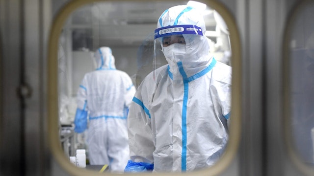 People in PPE work in the Huo-Yan (Fire Eye) Laboratory designed for high-capacity 2019-nCoV (SARS-CoV-2) detection in Wuhan in central China