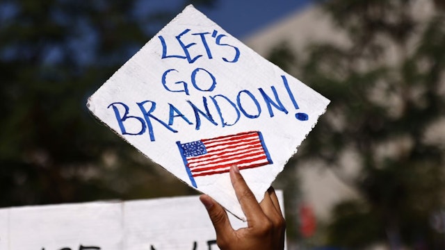 LOS ANGELES, CALIFORNIA - NOVEMBER 08: A protestor holds a 'Let's Go Brandon!' sign in Grand Park at a ‘March for Freedom’ rally demonstrating against the L.A. City Council’s COVID-19 vaccine mandate for city employees and contractors on November 8, 2021 in Los Angeles, California. The City Council has set a deadline of December 18 for all city employees and contractors to be vaccinated except for those who have religious or medical exemptions. (Photo by
