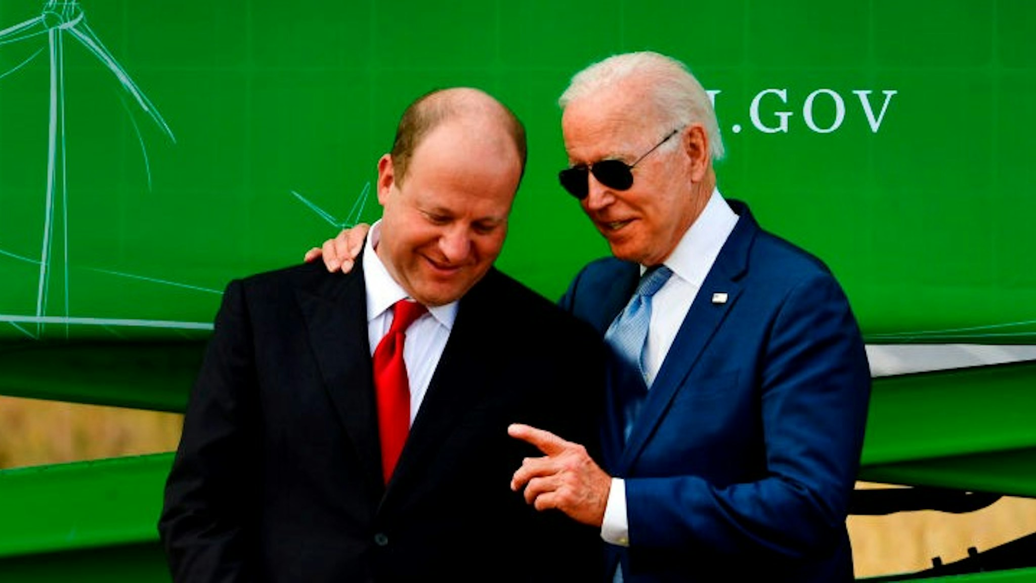 ARVADA, CO - SEPTEMBER 14: President Joe Biden, right, speaks with Colorado Governor Jared Polis before making remarks during a press conference on the grounds of National Renewable Energy Laboratory (NREL) on September 14, 2021 in Arvada, Colorado. Biden was in Colorado to visit NREL and to deliver remarks underscoring how the investments in his Bipartisan Infrastructure Deal and Build Back Better Agenda will help tackle the climate crisis, modernize our infrastructure and strengthen our country's resilience while creating good-paying jobs, union jobs and advancing environmental justice. (Photo by