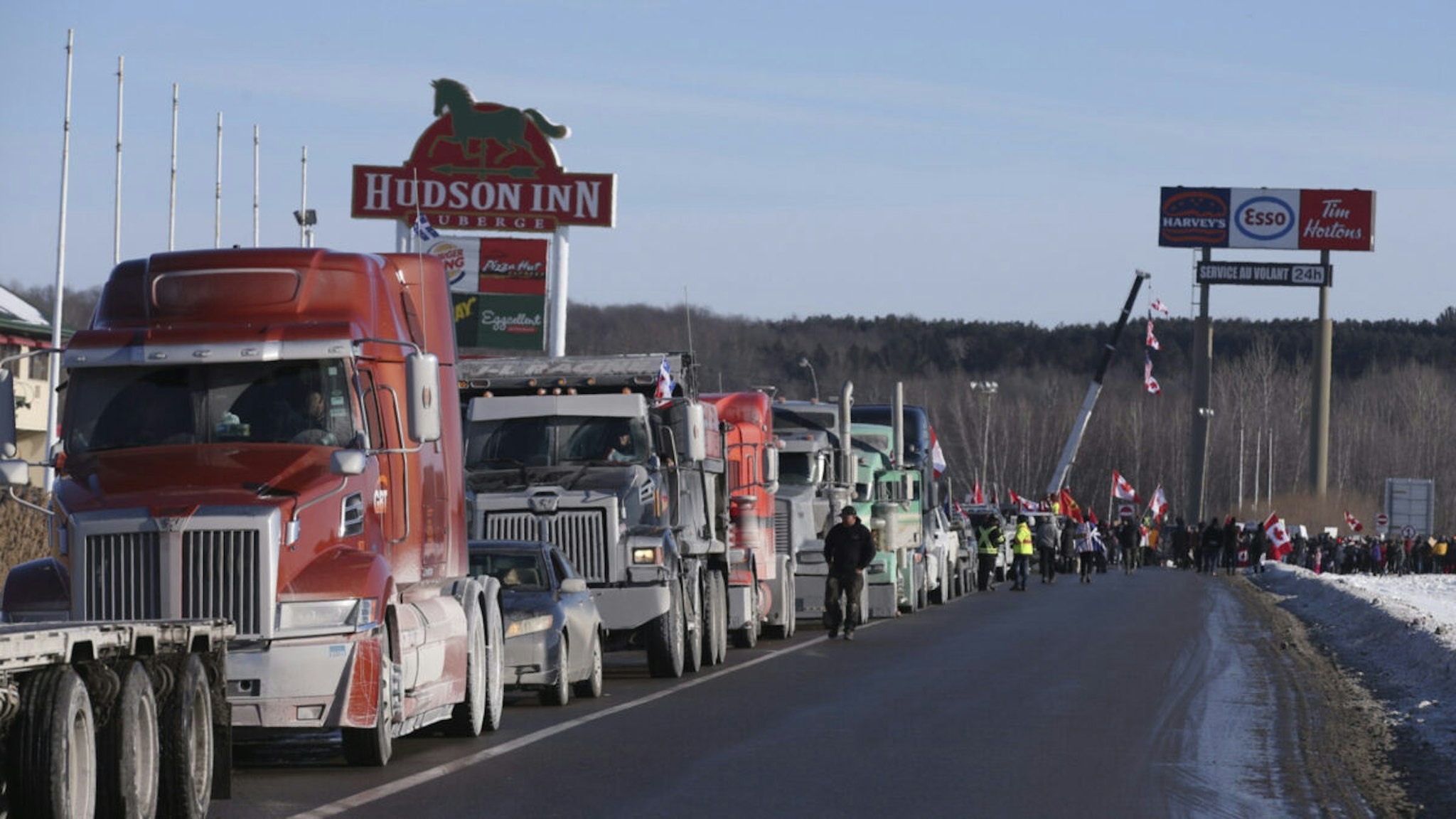 A convoy of trucks lines up on an on-ramp in Rigaud, Quebec, Canada, on Friday, Jan. 28, 2022.