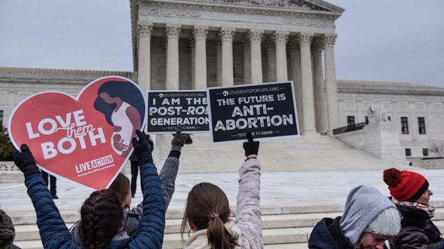 Demonstrators hold signs in front of the Supreme Court building during the annual March For Life on the National Mall in Washington, D.C., U.S., on Friday, Jan. 21, 2022.