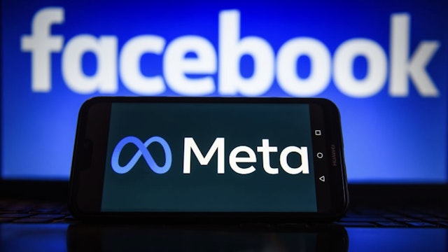 In this photo illustration a Meta logo seen displayed on a... POLAND - 2022/01/03: In this photo illustration a Meta logo seen displayed on a smartphone with Facebook logo in the background. (Photo Illustration by Omar Marques/SOPA Images/LightRocket via Getty Images) SOPA Images / Contributor