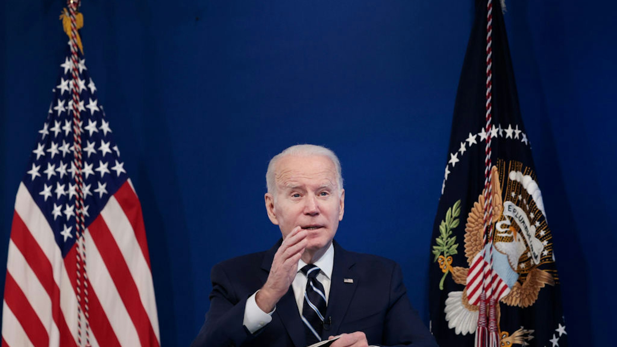 WASHINGTON, DC - JANUARY 13: U.S. President Joe Biden gestures as he gives remarks on his administration's response to the surge in COVID-19 cases across the country from the South Court Auditorium in the Eisenhower Executive Office Building on January 13, 2022 in Washington, DC. During the remarks President Biden urged unvaccinated individuals to seek the vaccine and highlighted his plan to distribute free COVID-19 tests and masks to the American people.