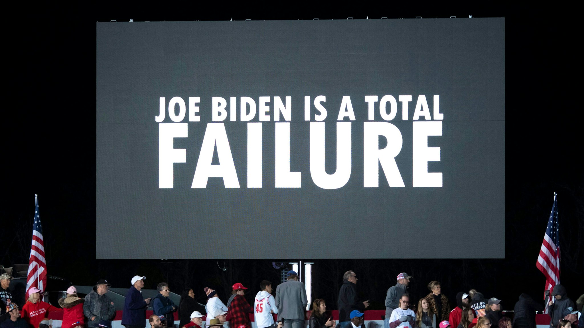 A screen reads "Joe Biden is a total failure" during a "Save America" rally with former US President Donald Trump in Conroe, Texas on January 29, 2022.