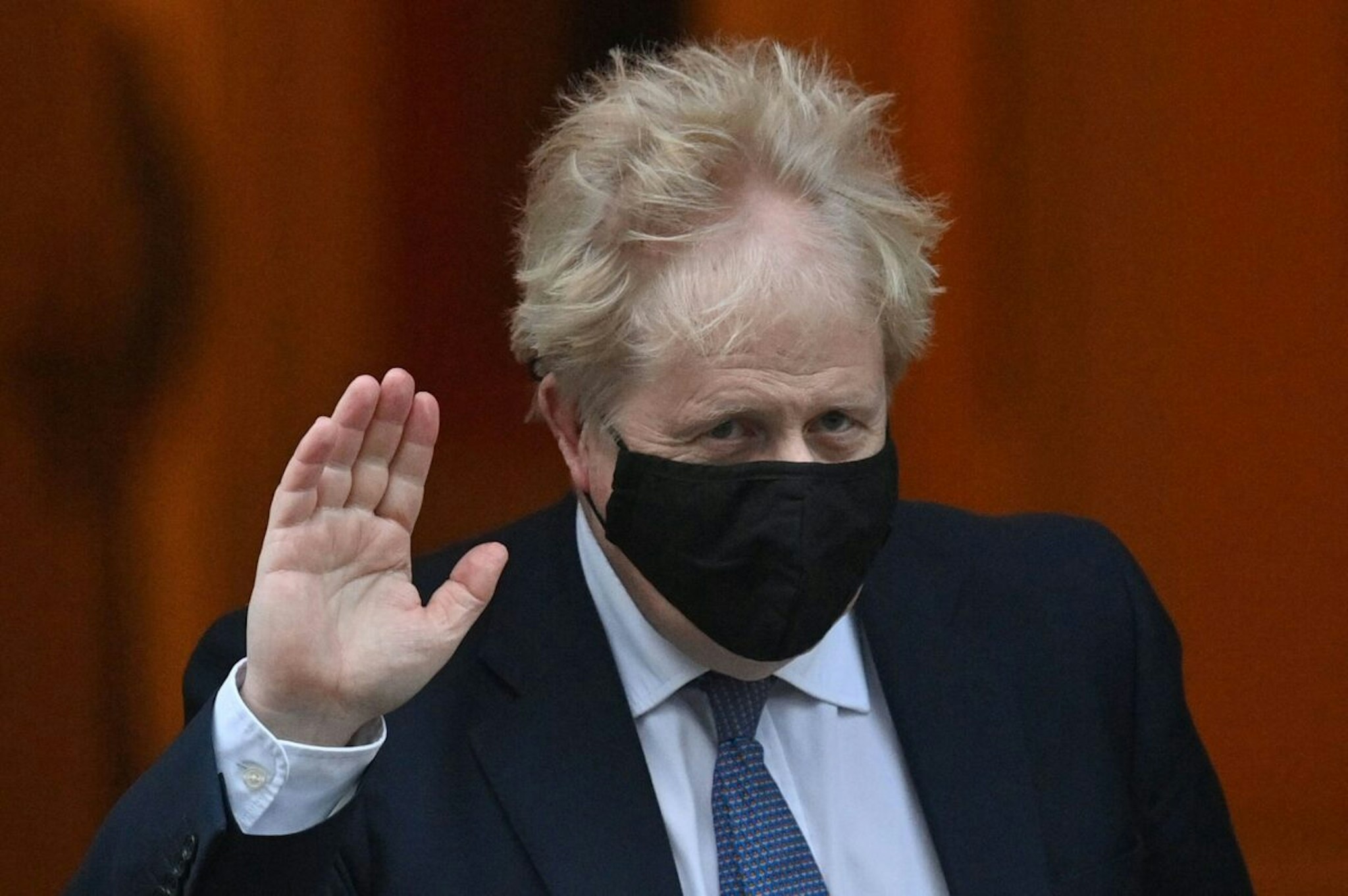 Britain's Prime Minister Boris Johnson, wearing a face covering to help mitigate the spread of coronavirus, leaves from 10 Downing Street in central London on January 5, 2022, to take part in the weekly session of Prime Minister Questions (PMQs) at the House of Commons.