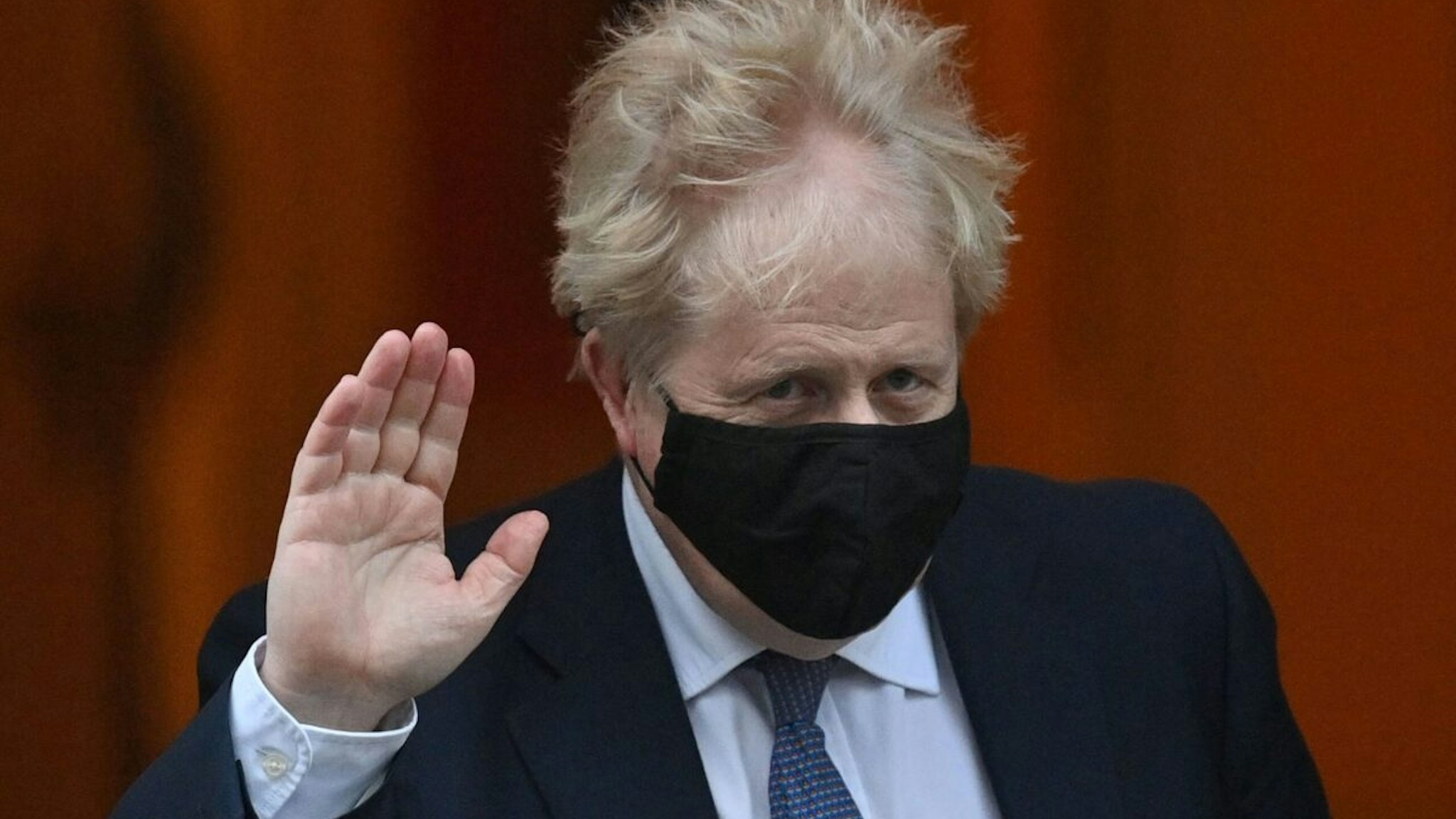 Britain's Prime Minister Boris Johnson, wearing a face covering to help mitigate the spread of coronavirus, leaves from 10 Downing Street in central London on January 5, 2022, to take part in the weekly session of Prime Minister Questions (PMQs) at the House of Commons.