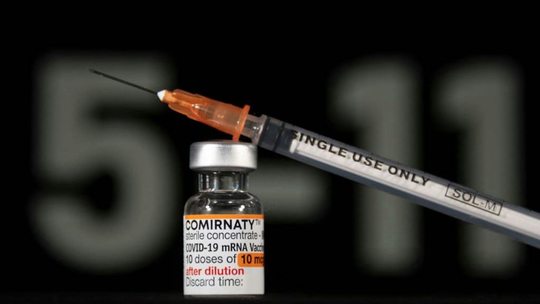 Covid-19 vaccine A vial of Pfizer/BioNTech Covid-19 vaccine for children and labelled with an orange coloured band, is pictured with a syringe in Mulhouse, eastern France, on December 23, 2021. (Photo by SEBASTIEN BOZON / AFP) (Photo by SEBASTIEN BOZON/AFP via Getty Images)