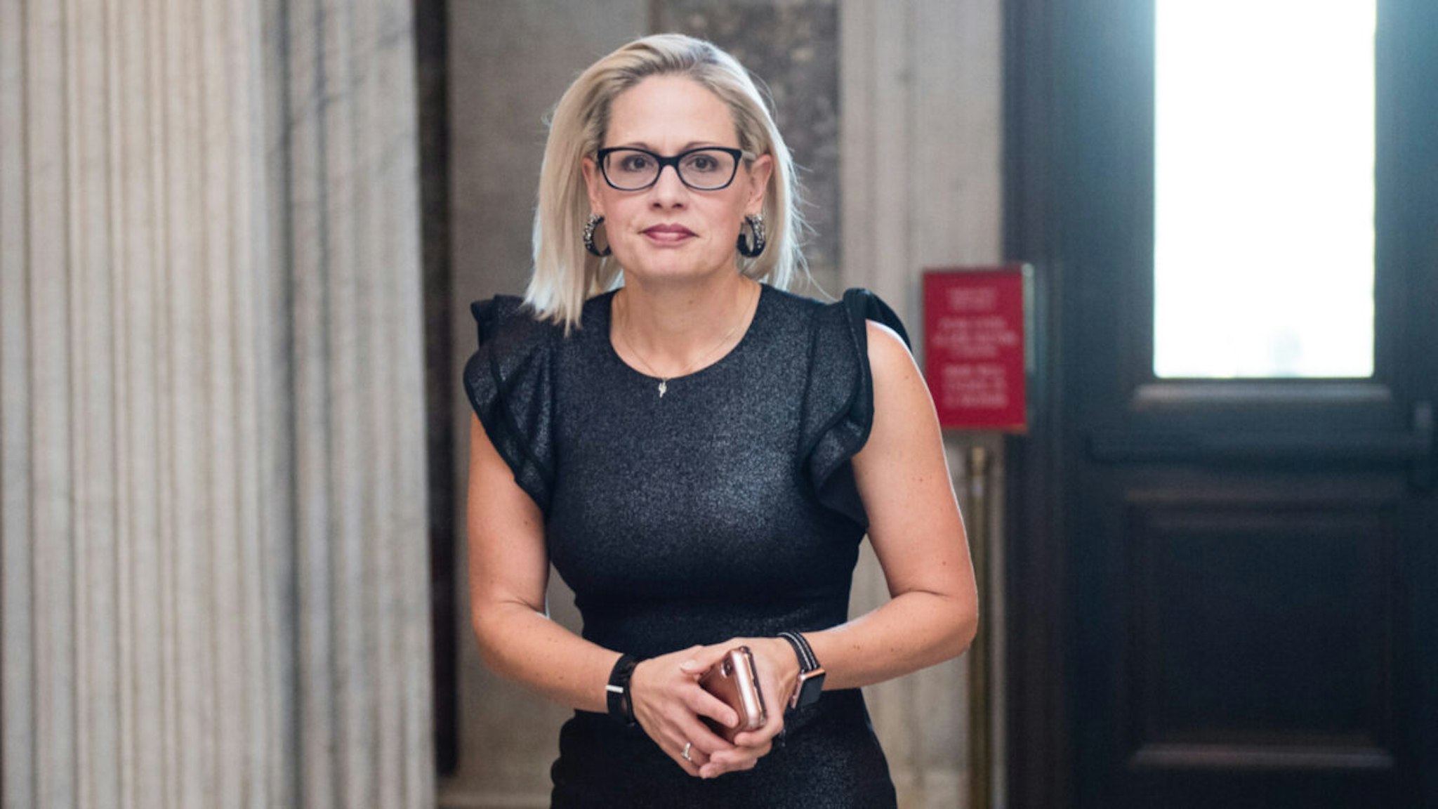 Sen. Kyrsten Sinema, D-Ariz., arrives for the votes in the Senate to keep the government open on Feb. 14, 2019.