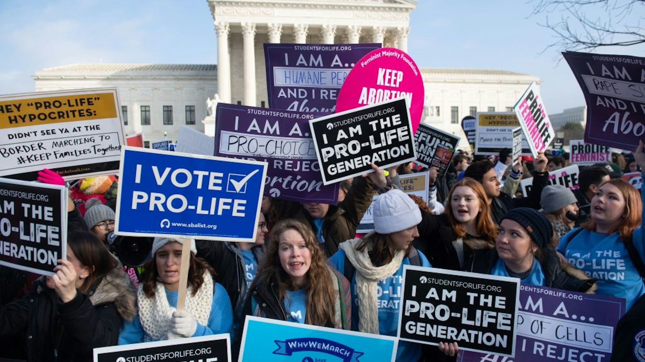 Pro-choice activists hold signs in response to anti-abortion activists participating in the "March for Life," an annual event to mark the anniversary of the 1973 Supreme Court case Roe v. Wade, which legalized abortion in the US, outside the US Supreme Court in Washington, DC, January 18, 2019. (Photo by SAUL LOEB / AFP) (Photo credit should read SAUL LOEB/AFP via Getty Images)