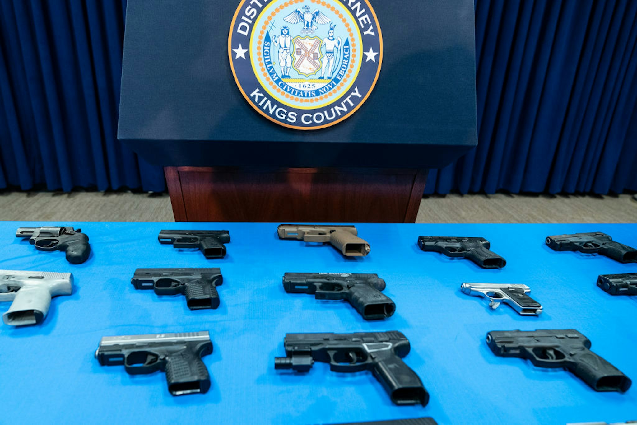 Guns confiscated from gang members on display during Brooklyn District Attorney Eric Gonzalez press conference in District Attorney office.