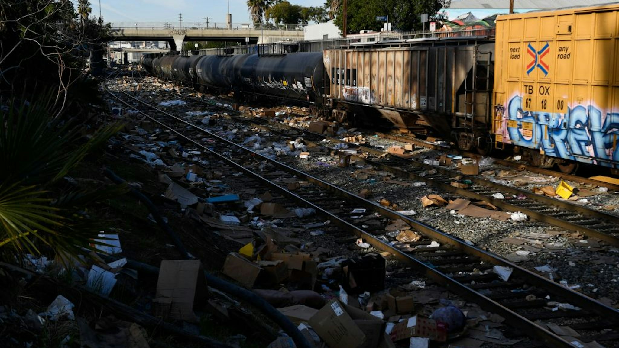 A section of Union Pacific train tracks littered with thousands of opened boxes and packages stolen from cargo shipping containers, targeted by thieves as the trains stop in downtown Los Angeles, California on January 14, 2022.