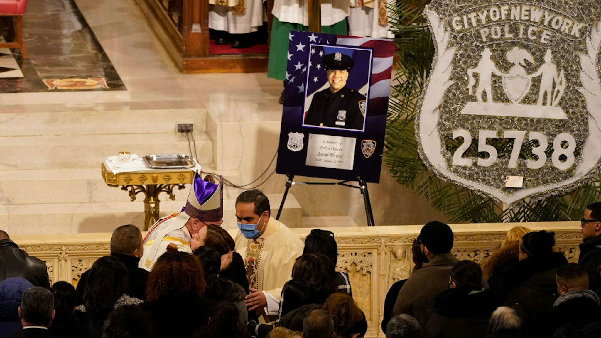 NEW YORK, NY - JANUARY 28: Cardinal Timothy Dolan (L) hugs family and friends of Officer Jason Rivera at the start of Riveras funeral service inside St. Patricks Cathedral on January 28, 2022 in New York, NY. Rivera and his partner, Officer Wilbert Mora, were fatally wounded when a gunman ambushed them in an apartment as they responded to a family dispute last week. (Photo by Mary Altaffer-Pool/Getty Images)