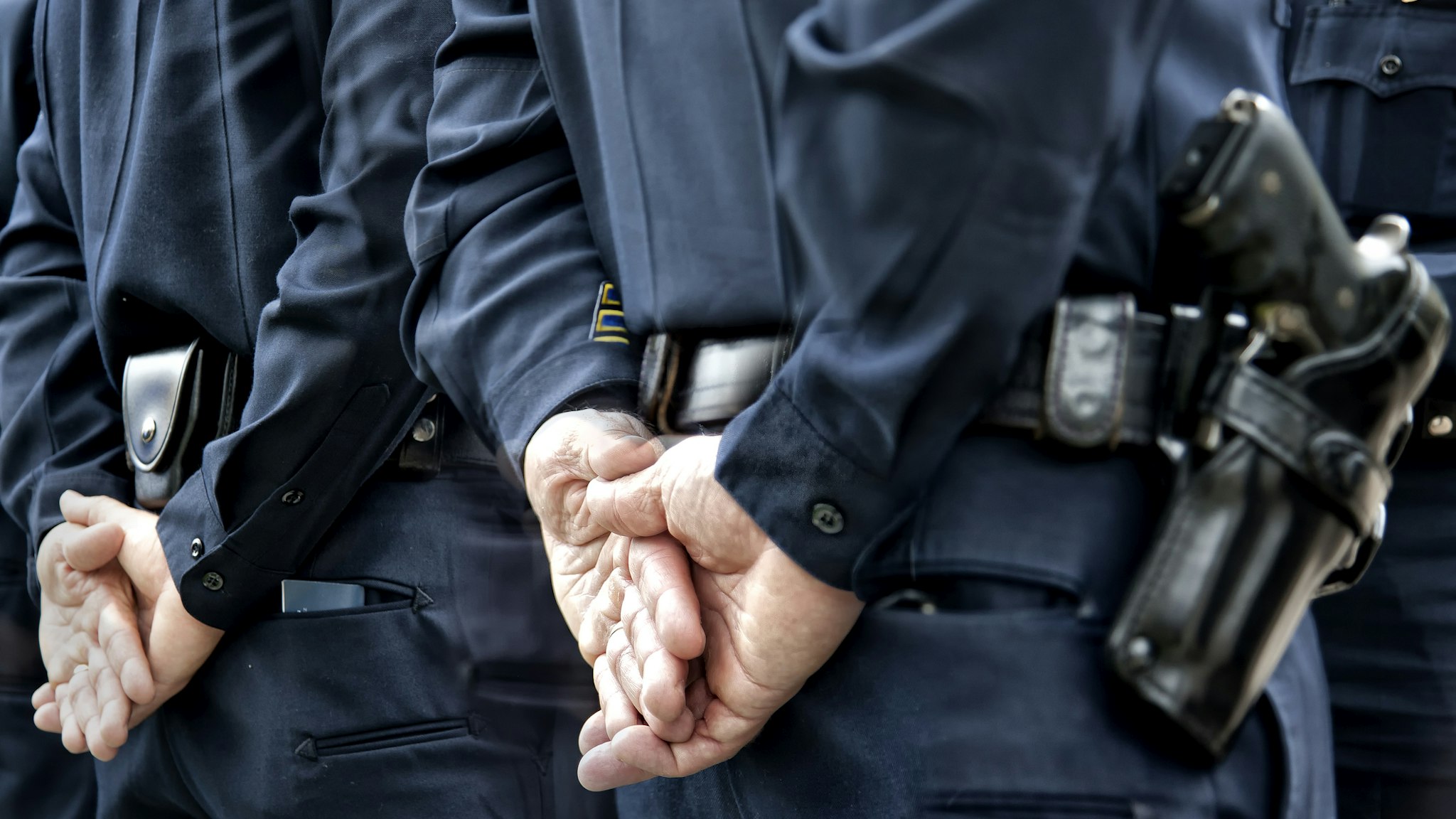 Officers standing with hands behind - stock photo