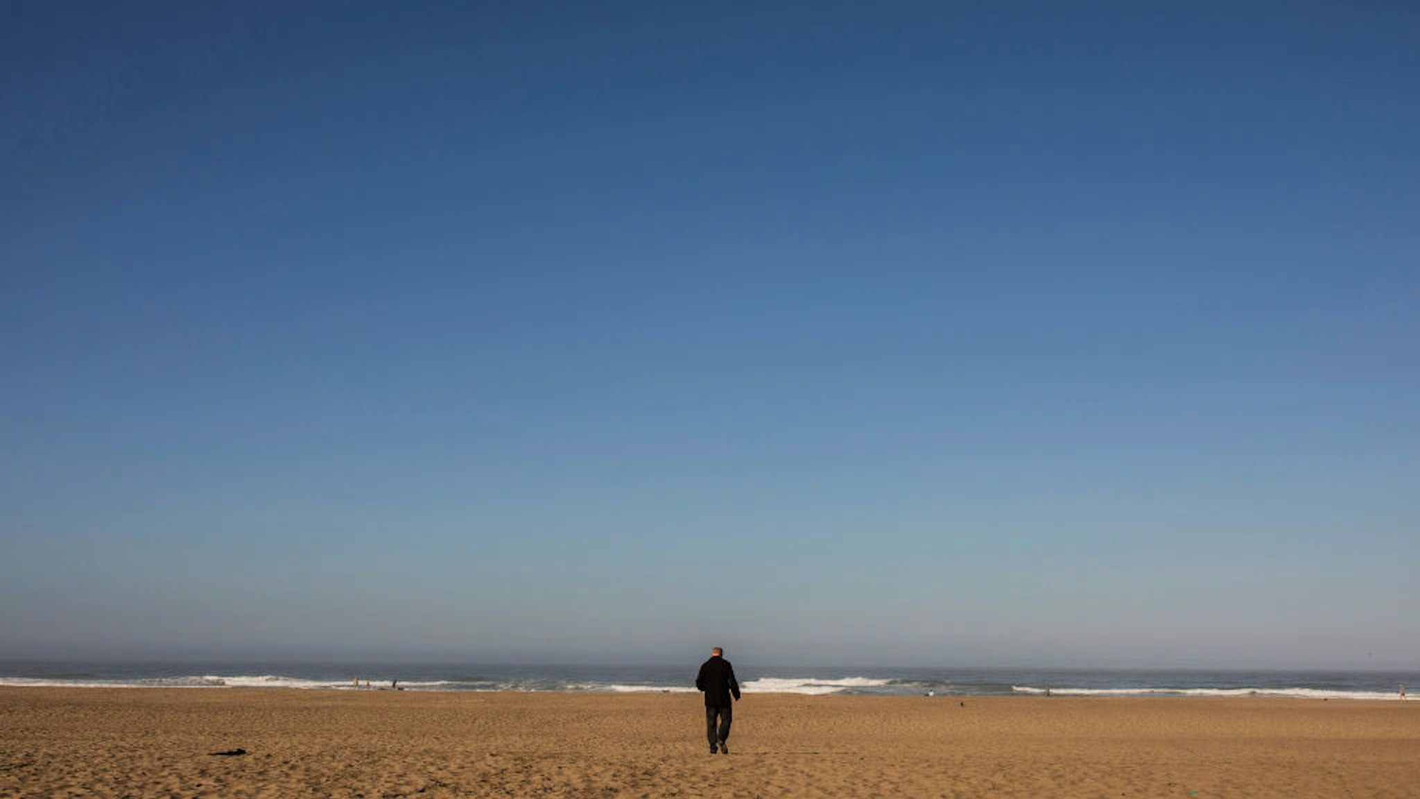 Police inspector Dan Cunningham counts his steps to find the approximate location of a crime scene at Ocean Beach, Tuesday, Oct. 13, 2020, in San Francisco, Calif.