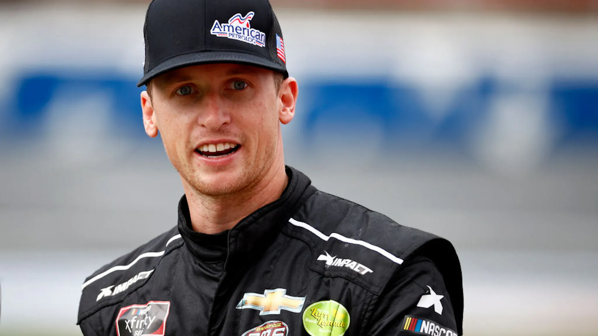 NASCAR Xfinity Series Drive for the Cure 250 presented by Blue Cross Blue Shield of North Carolina Brandon Brown, driver of the #68 American PetroLog Chevrolet, walks the grid prior to the NASCAR Xfinity Series Drive for the Cure 250 presented by Blue Cross Blue Shield of North Carolina at Charlotte Motor Speedway on October 09, 2021 in Concord, North Carolina.