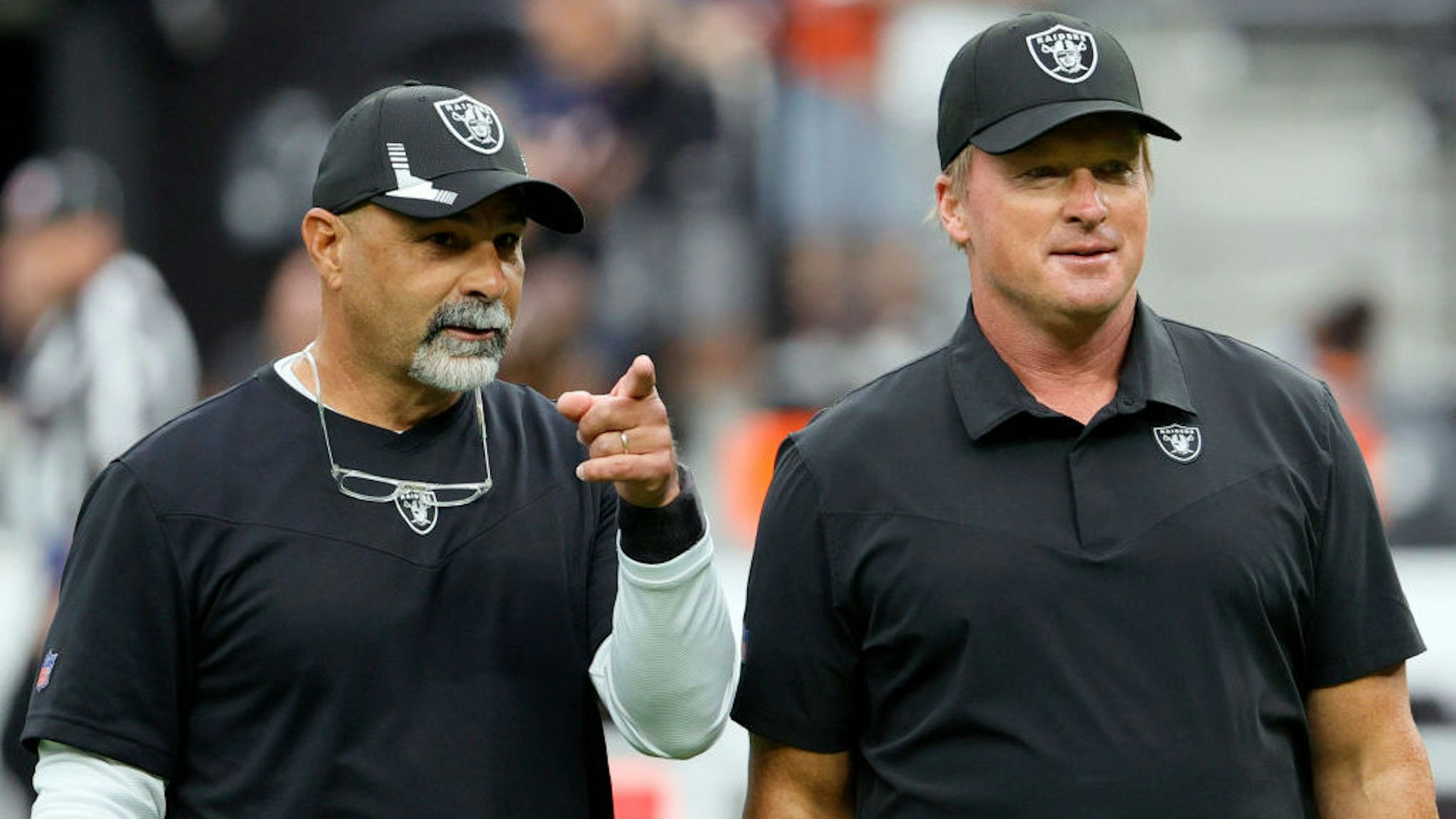 LAS VEGAS, NEVADA - OCTOBER 10: Assistant head coach/special teams coordinator Rich Bisaccia (L) and head coach Jon Gruden of the Las Vegas Raiders talk on the field before their game against the Chicago Bears at Allegiant Stadium on October 10, 2021 in Las Vegas, Nevada. The Bears defeated the Raiders 20-9. (Photo by Ethan Miller/Getty Images)