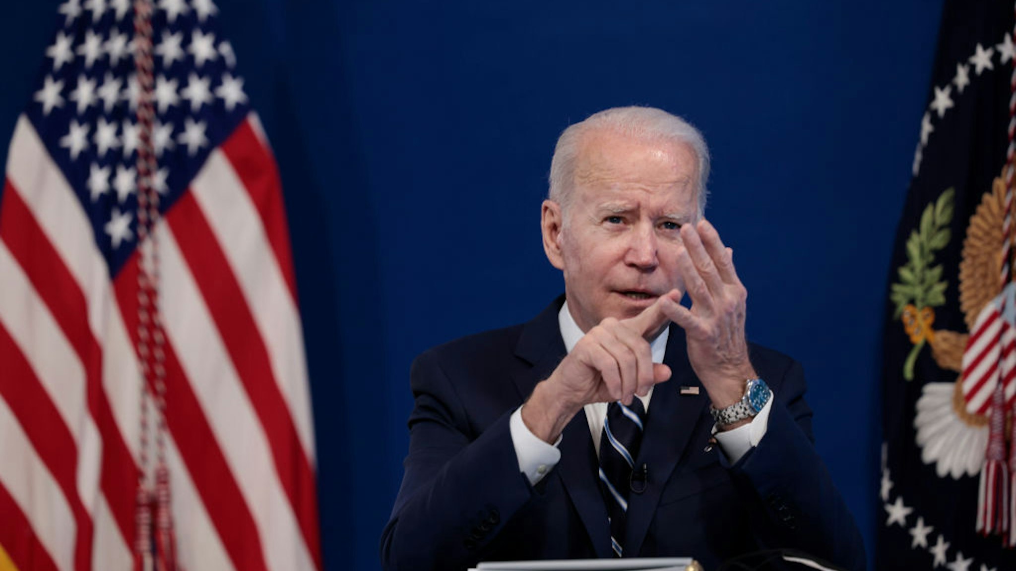 WASHINGTON, DC - JANUARY 13: U.S. President Joe Biden gestures as he gives remarks on his administration's response to the surge in COVID-19 cases across the country from the South Court Auditorium in the Eisenhower Executive Office Building on January 13, 2022 in Washington, DC. During the remarks President Biden urged unvaccinated individuals to seek the vaccine and highlighted his plan to distribute free COVID-19 tests and masks to the American people. (Photo by Anna Moneymaker/Getty Images)