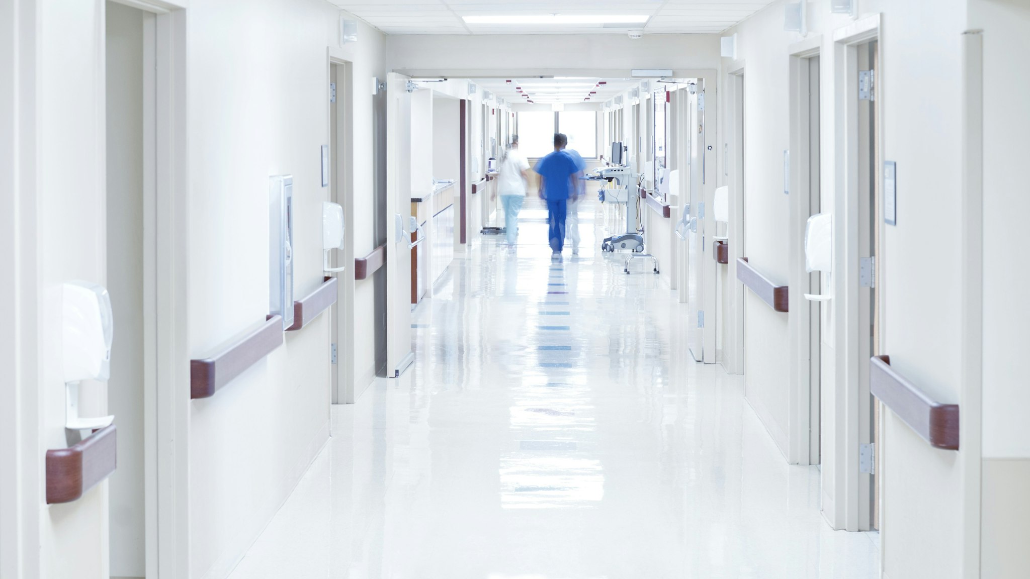 Doctor walking down hospital corridor.