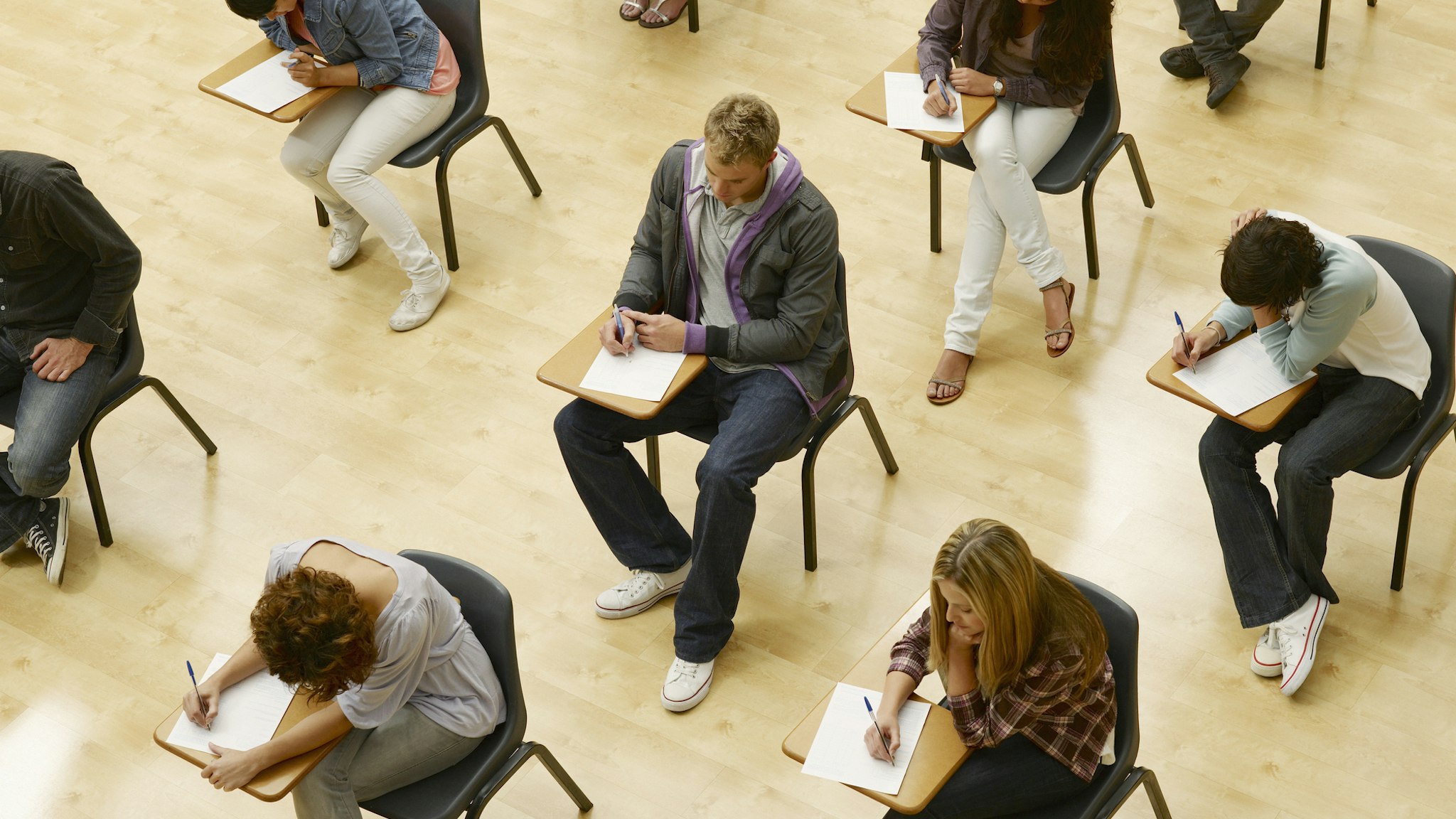 College students taking test in classroom - stock photo