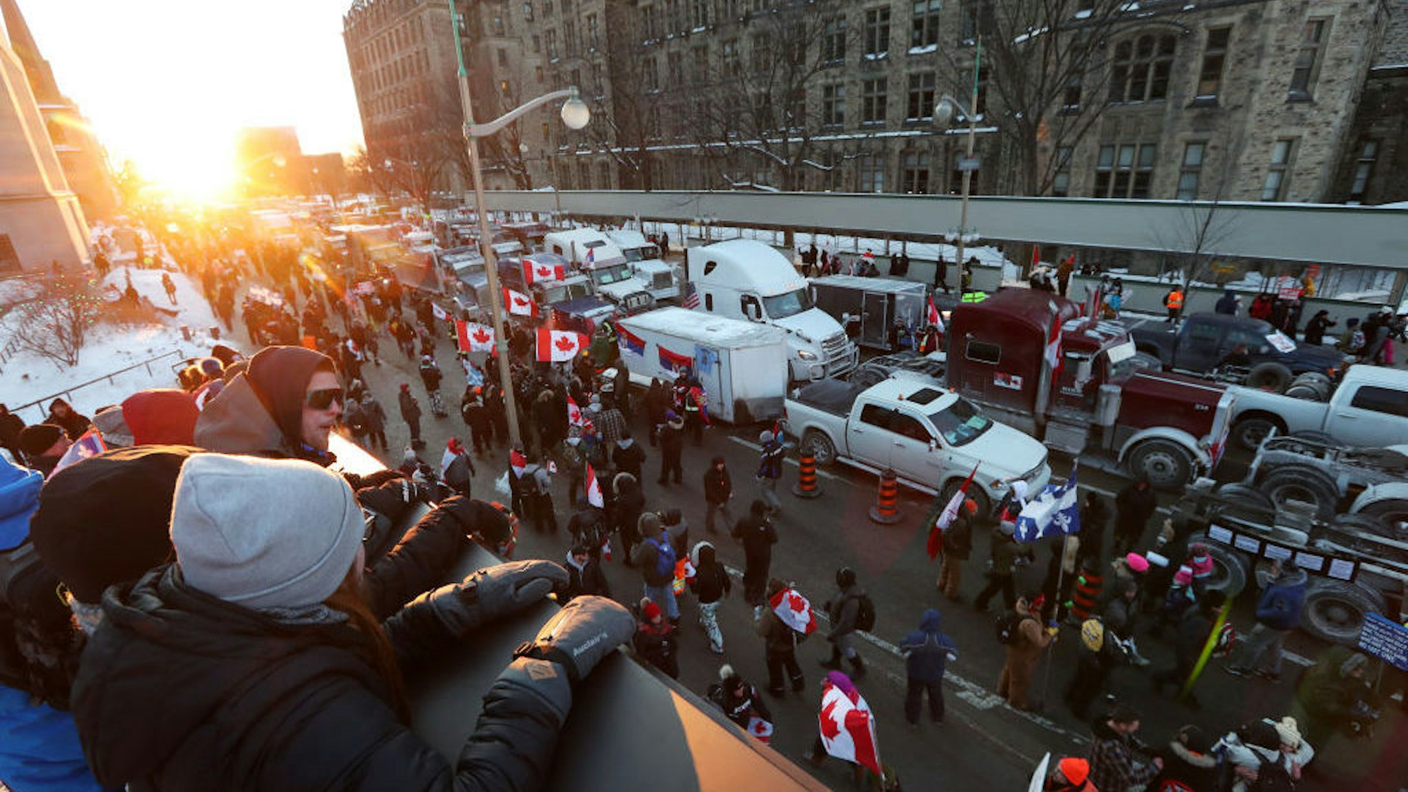 Demonstrators gather as rows of trucks sit parked on Wellington Street during a protest near Parliament Hill in Ottawa, Ontario, Canada, on Saturday, Jan. 29, 2022. A convoy of truckers and others who oppose vaccine mandates began rolling into Ottawa on Friday, putting Canada's capital city on edge amid warnings from police that they don’t know how large the protests will get. Photographer: David Kawai/Bloomberg