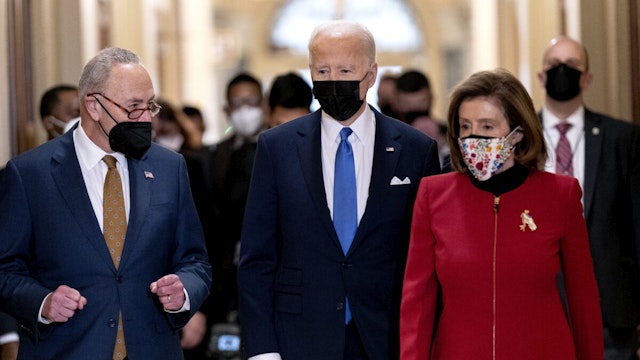 U.S. President Joe Biden, center, joined by Senate Majority Leader Chuck Schumer, (D-NY), left, and U.S. House Speaker Nancy Pelosi, (D-NY),