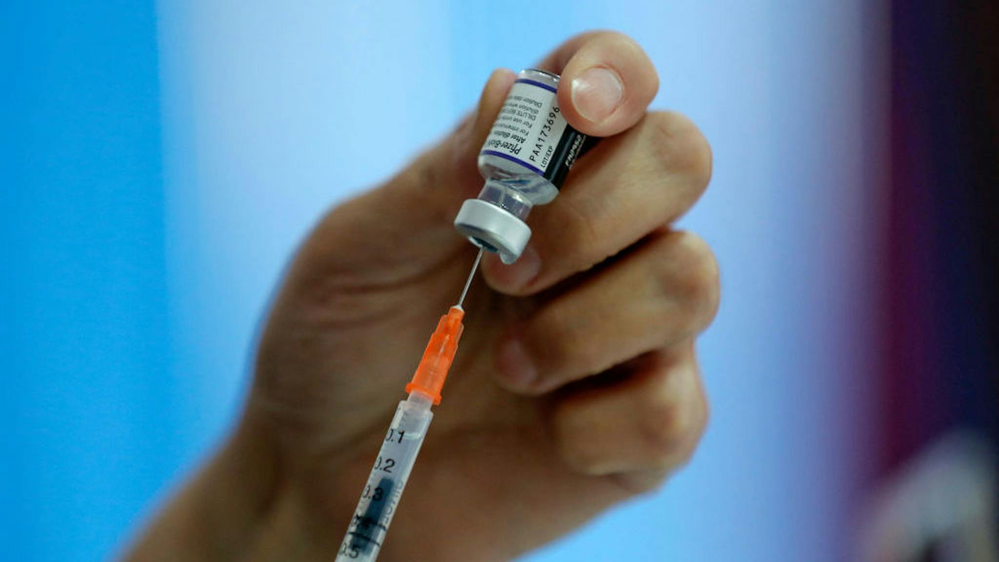 Pfizer-BioNTech vaccine A health worker prepares a dose of the Pfizer-BioNTech vaccine against COVID-19 at a vaccination center in Santiago, on January 20, 2022. - Chile registered this Thursday a new record of daily infections, with 12,500 new infected, the highest number in the entire pandemic, in one of the countries with the highest percentage of its population vaccinated and that this Thursday began to apply the fourth dose to health personnel. (Photo by JAVIER TORRES / AFP) (Photo by JAVIER TORRES/AFP via Getty Images)
