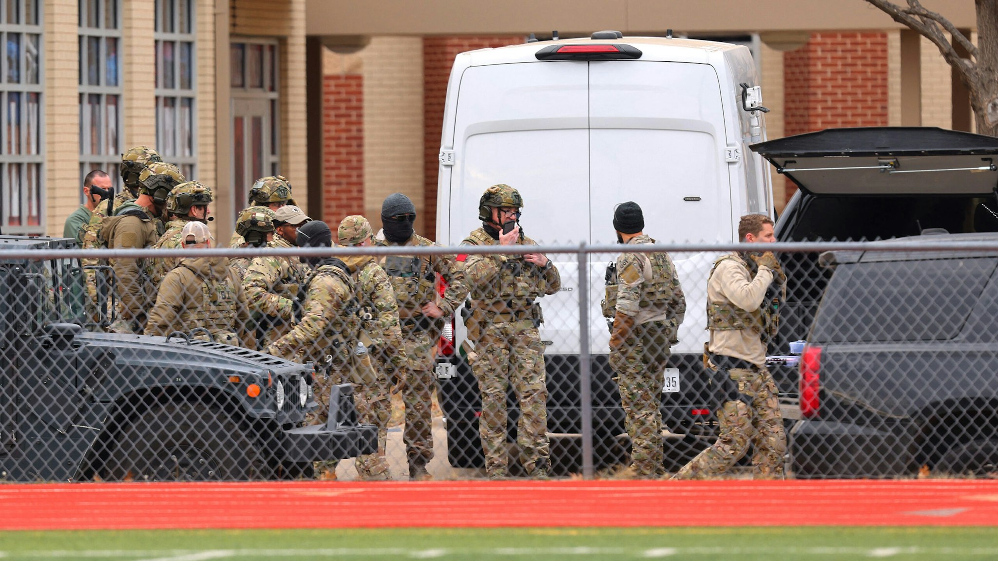 SWAT team members deploy near the Congregation Beth Israel Synagogue in Colleyville, Texas, some 25 miles (40 kilometers) west of Dallas, on January 15, 2022. - The SWAT police operation was underway at the synagogue where a man claiming to be the brother of a convicted terrorist has reportedly taken several people hostage, police and media said.