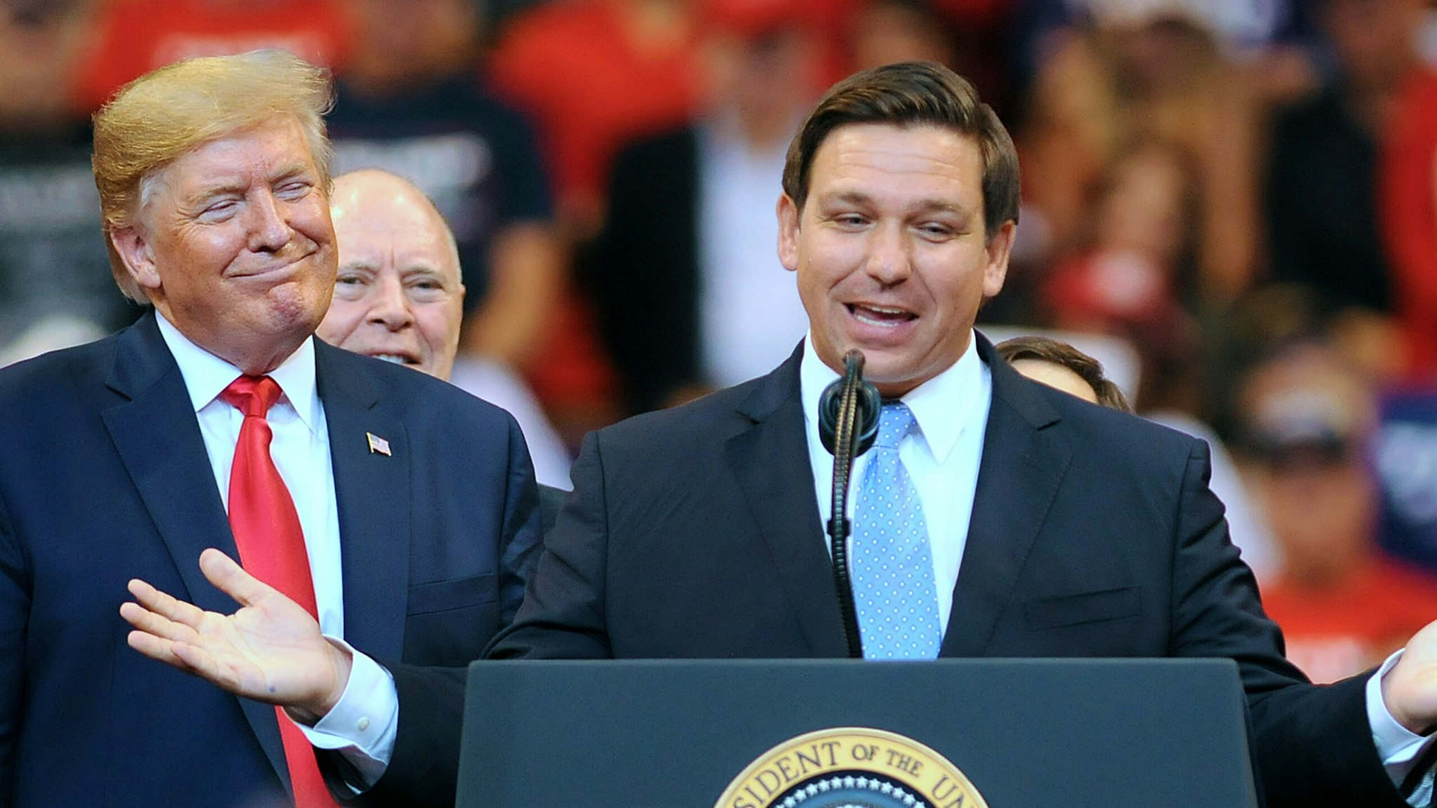 SUNRISE, FLORIDA, UNITED STATES - 2019/11/26: U.S. President Donald Trump looks on as Florida Governor Ron DeSantis speaks during the Florida Homecoming rally at the BB&amp;T Center. Trump recently became an official resident of the state of Florida.