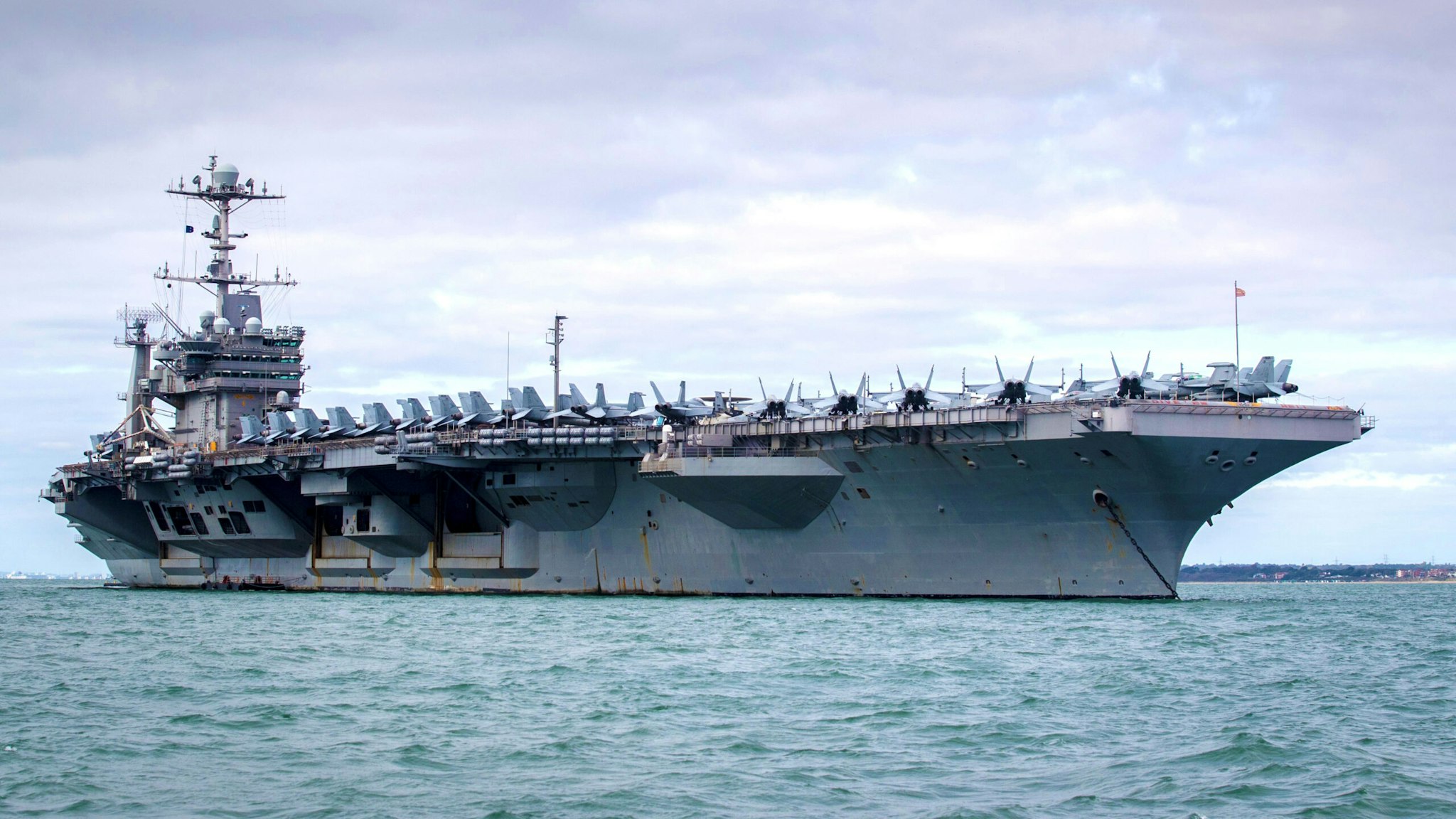 PORTSMOUTH, ENGLAND - OCTOBER 08: The US warship USS Harry S. Truman is pictured anchored in The Solent on October 8, 2018 near Portsmouth, England. The nuclear powered aircraft carrier, named after the 33rd President of the United States with a crew of more than 5,000, has been at sea since late August and has been on operations in the North Atlantic, Mediterranean and Arabian Gulf. The Nimitz-class ship, launched in 1998 and carries more than 70 helicopters and fixed-wing aircraft, arrived in The Solent on Saturday for a five-day stay.